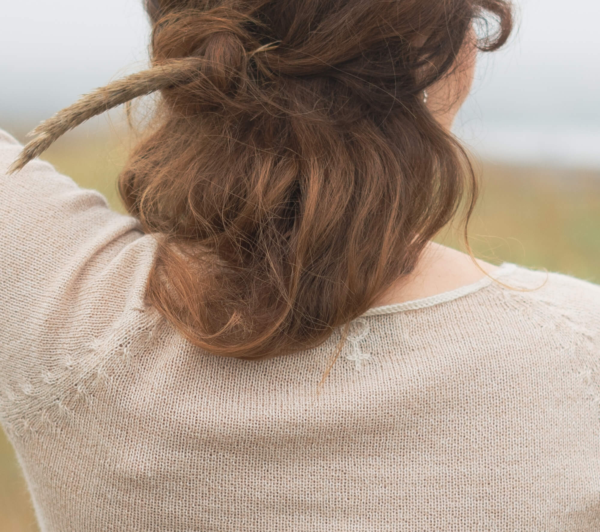Close-up of a soft knit sweater and loose hair