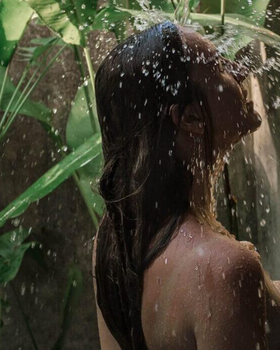 Ozenia Spa brand photograph of a woman beneath falling water